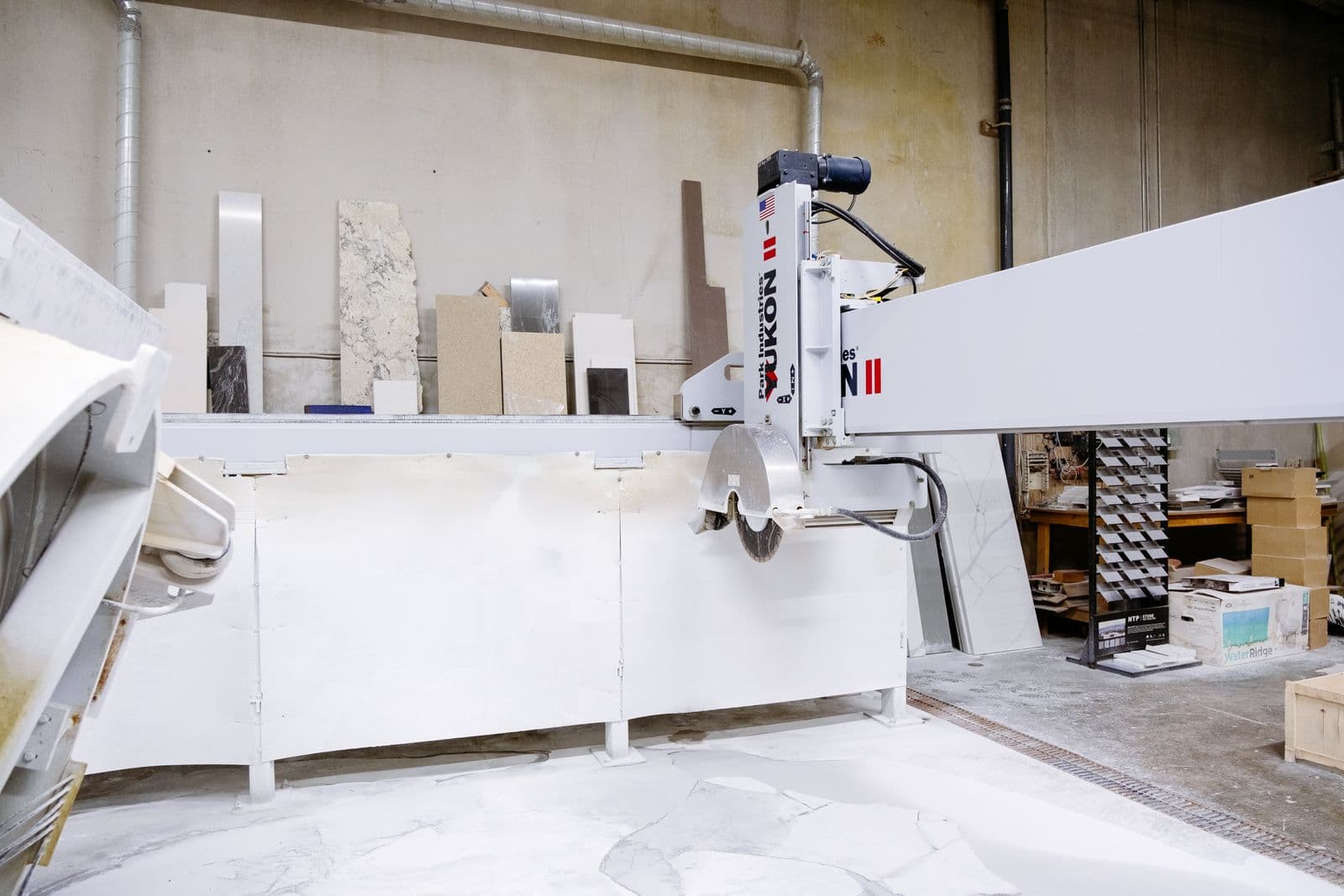 CNC bridge saw cutting a quartz slab in the StoneForm fabrication shop